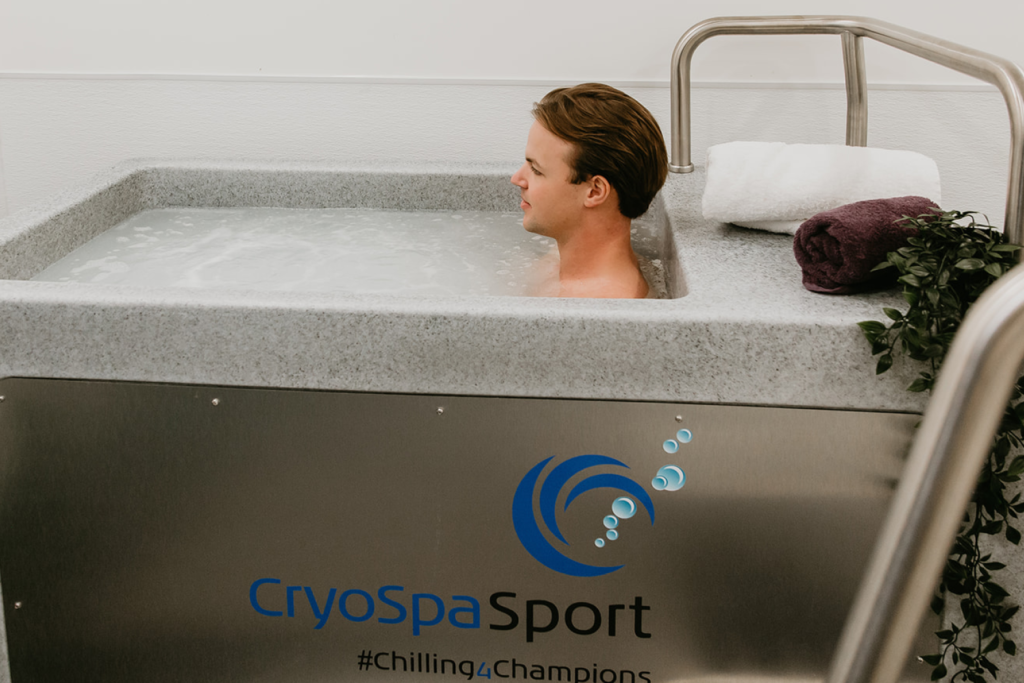 A man in a CryoSpa cold water bath to feel the mental and physical health benefits.