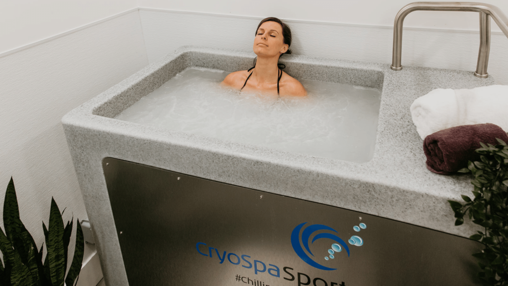 A woman in a CryoSpa cold therapy tub for the recommended duration of 2–10 minutes.
