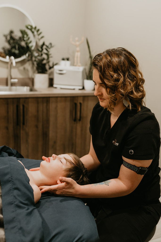 A patient getting a massage at Recovery Lab in Red Deer for chronic pain management.