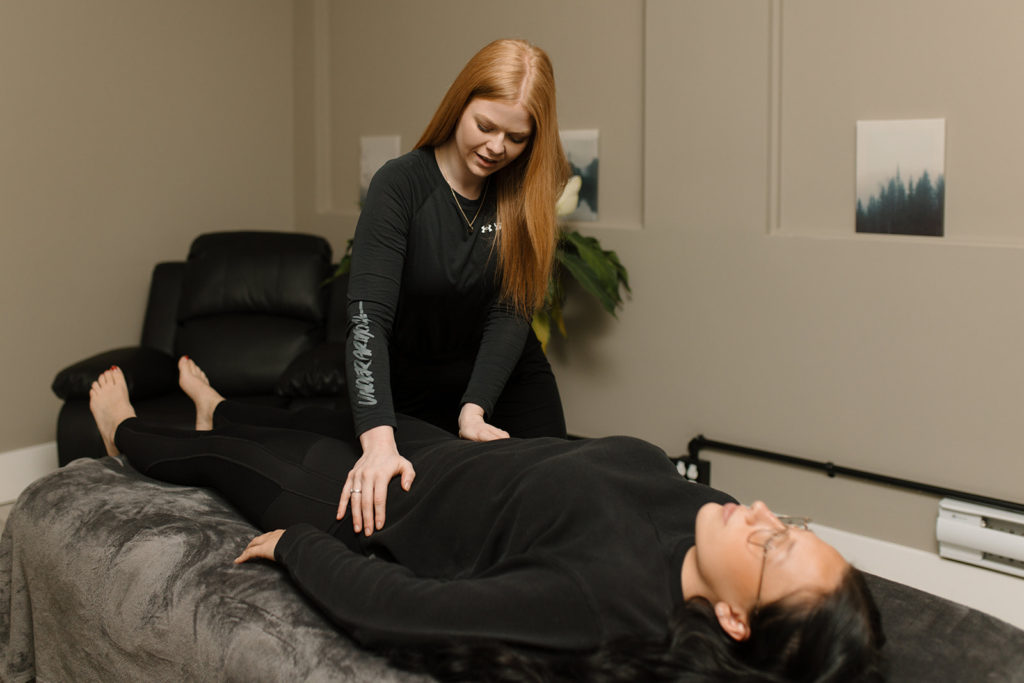 A manual osteopathy therapist treating a client for posture issues, lower back pain, tension, and more.